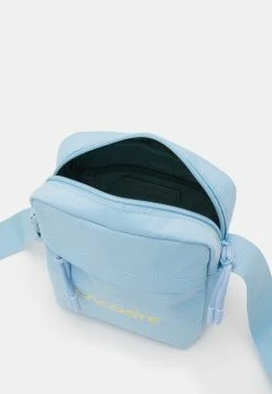 Lacoste UNISEX EXCLUSIVE - Across Body Bag - Light Blue -Lacoste Sales Store 02d9f979985441ccb607b62ef484c25a