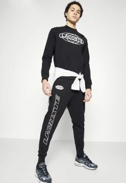 Lacoste EXCLUSIVE - Tracksuit Bottoms - Black -Lacoste Sales Store 0c2947458bbd481ba5ab1f52f0fcad78