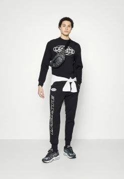 Lacoste EXCLUSIVE - Tracksuit Bottoms - Black -Lacoste Sales Store 169ef89977a540b8bc57c294cbce3899